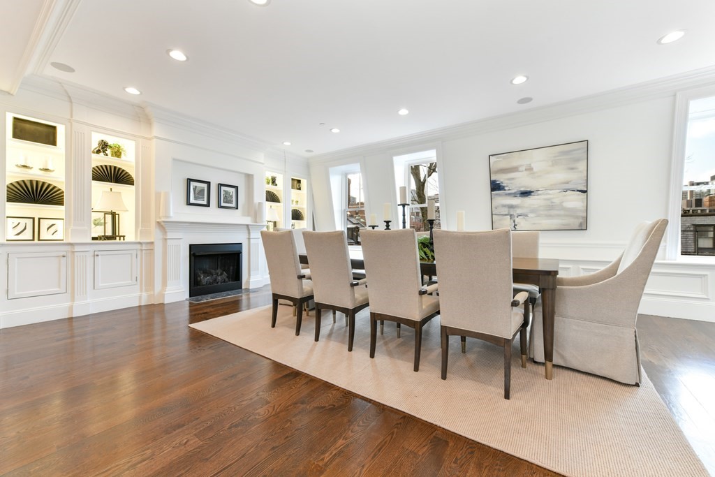 361 Beacon Street, Unit 3 Boston, MA 02116 - Photo 6 of 23 a view of a dining room with furniture wooden floor and a fireplace