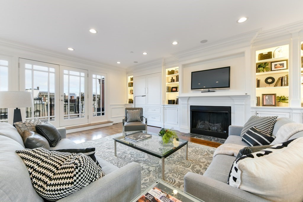 361 Beacon Street, Unit 3 Boston, MA 02116 - Photo 7 of 23 a living room with furniture a flat screen tv and a fireplace