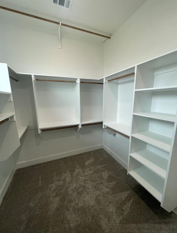 1484 Dixie Road Whitesboro, TX 76273 - Photo 15 of 18 a room with a closet and wooden shelves