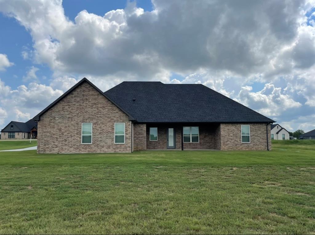 1484 Dixie Road Whitesboro, TX 76273 - Photo 18 of 18 a brick house with a big yard and large trees