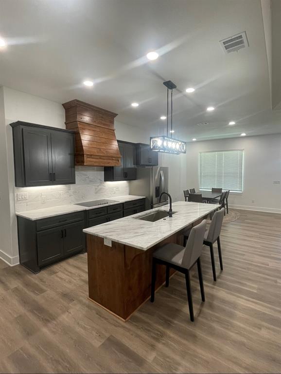 1484 Dixie Road Whitesboro, TX 76273 - Photo 5 of 18 a kitchen with stainless steel appliances kitchen island a cabinets and wooden floor