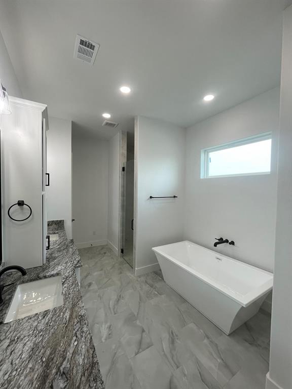 1484 Dixie Road Whitesboro, TX 76273 - Photo 8 of 18 a bathroom with a tub sink and mirror