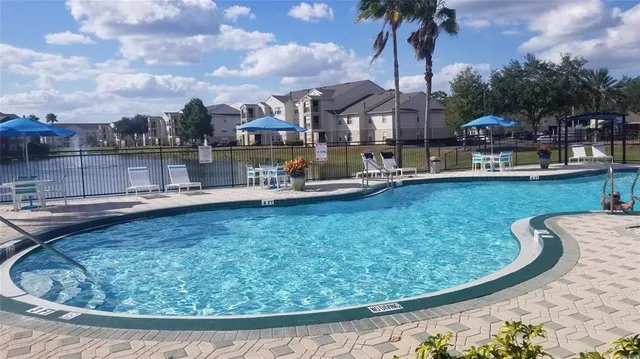a view of a swimming pool with outdoor seating