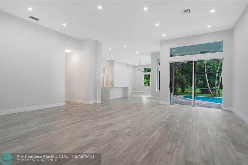 Cooper City Hollywood, FL 33024 - Photo 13 of 39 a view of an empty room with wooden floor and a window