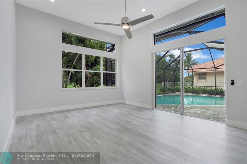 Cooper City Hollywood, FL 33024 - Photo 14 of 39 a view of an empty room with a window and wooden floor