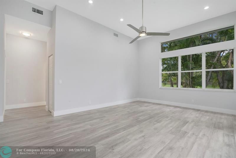 Cooper City Hollywood, FL 33024 - Photo 15 of 39 an empty room with wooden floor and windows