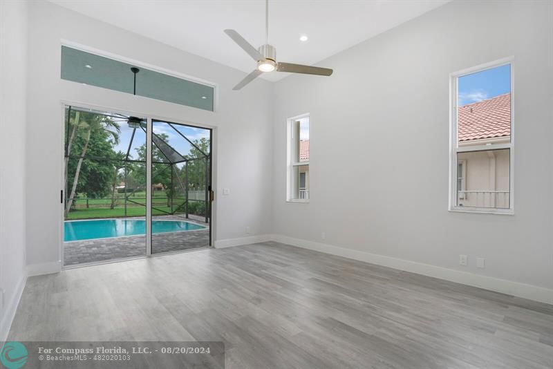 Cooper City Hollywood, FL 33024 - Photo 19 of 39 an empty room with wooden floor and outdoor view