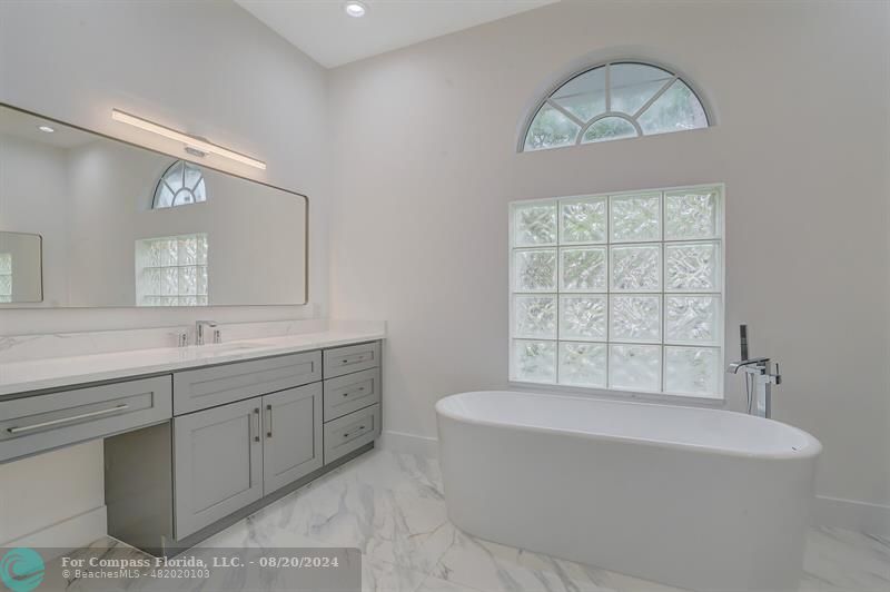 Cooper City Hollywood, FL 33024 - Photo 21 of 39 a spacious bathroom with a bathtub a sink and a window