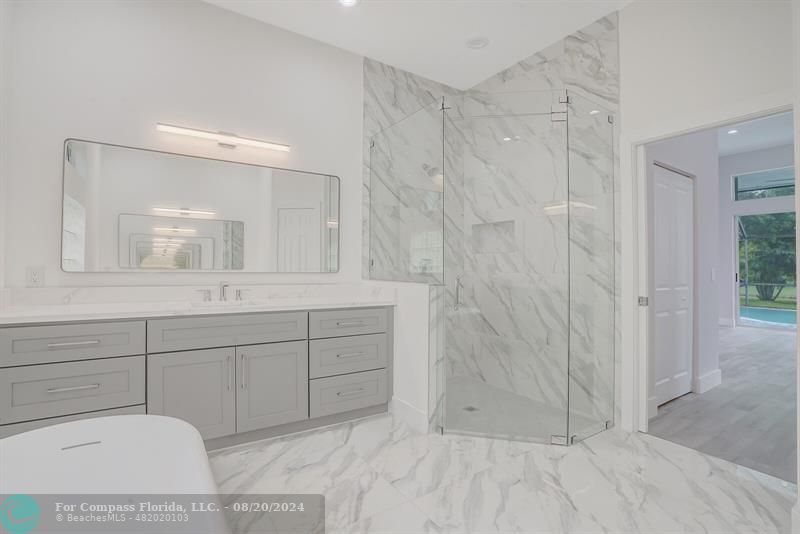 Cooper City Hollywood, FL 33024 - Photo 22 of 39 a bathroom with a sink and a mirror