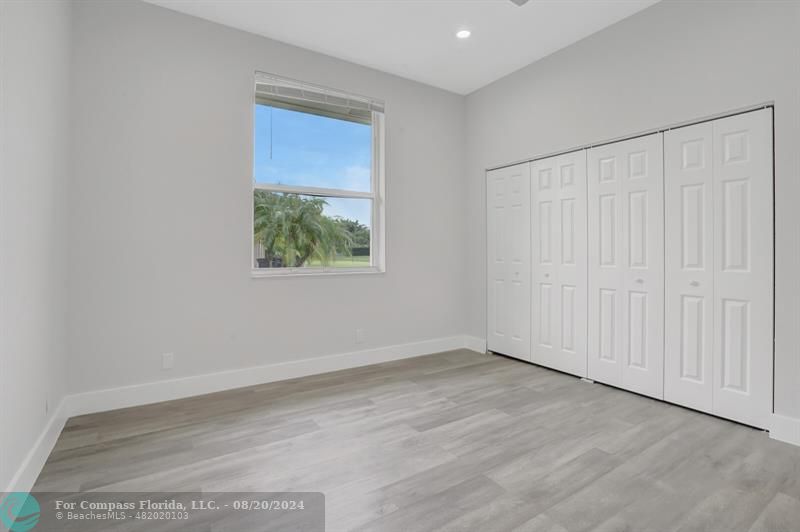 Cooper City Hollywood, FL 33024 - Photo 24 of 39 an empty room with wooden floor and windows