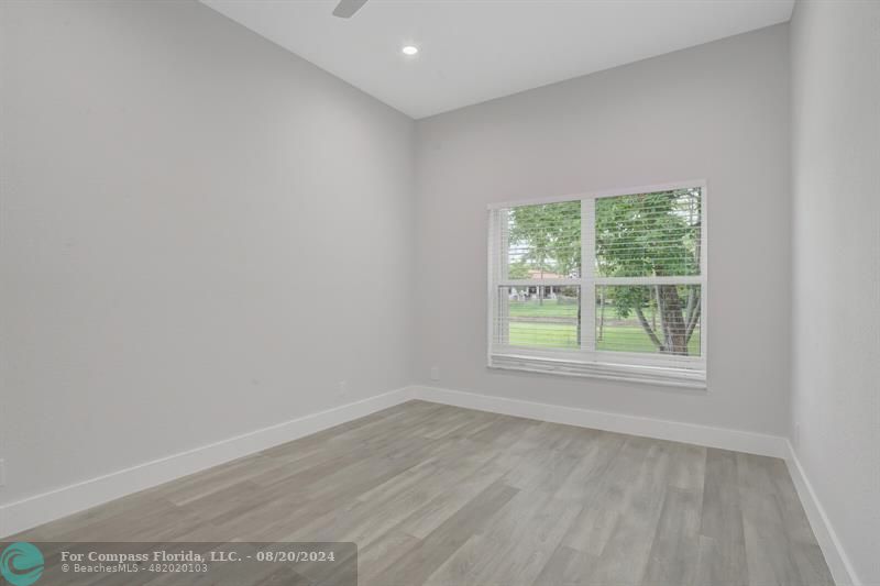 Cooper City Hollywood, FL 33024 - Photo 25 of 39 an empty room with wooden floor and windows