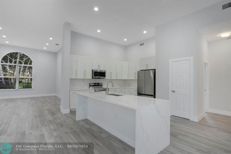 Cooper City Hollywood, FL 33024 - Photo 5 of 39 a kitchen with stainless steel appliances a refrigerator and a stove top oven