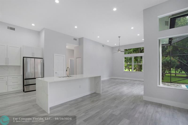 Cooper City Hollywood, FL 33024 - Photo 7 of 39 a large kitchen with stainless steel appliances a large counter top a sink and a refrigerator