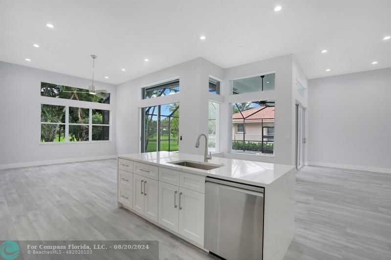 Cooper City Hollywood, FL 33024 - Photo 8 of 39 a large white kitchen with granite countertop a large window and white appliances