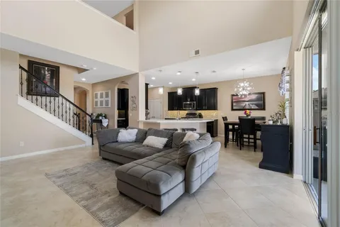 a living room with furniture and kitchen view