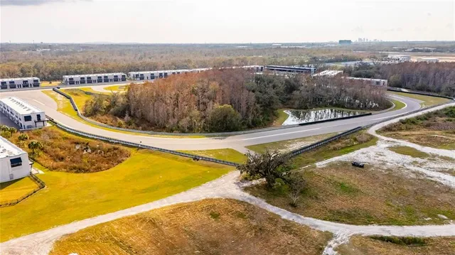 an aerial view of a swimming pool and outdoor seating