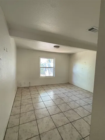 a view of an empty room and a window