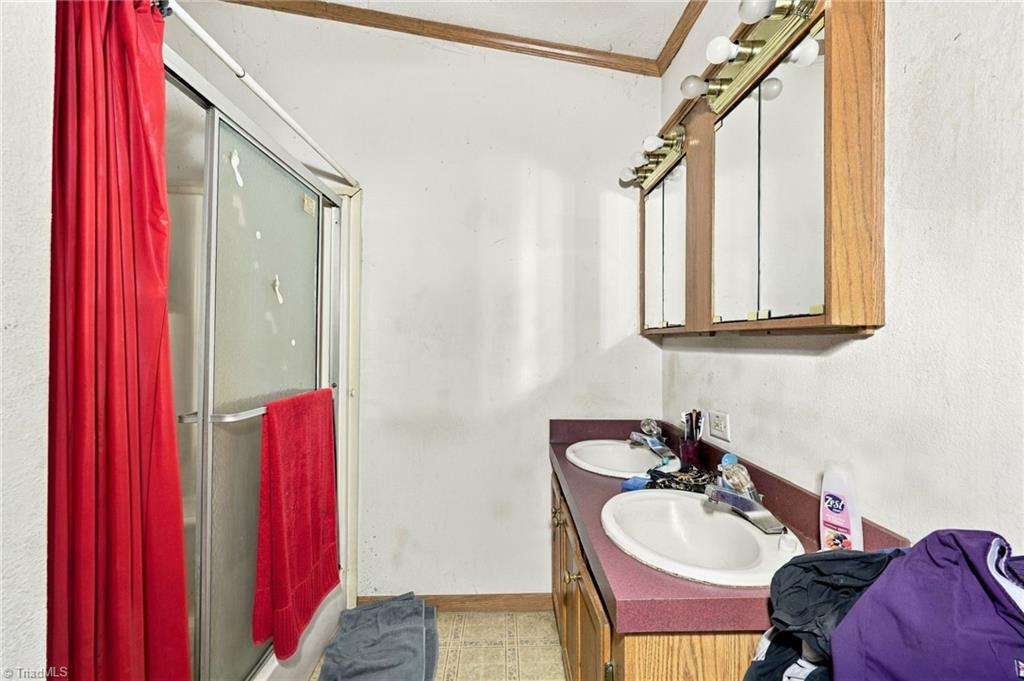 415 Talley Road Reidsville, NC 27320 - Photo 16 of 31 Full bathroom with double vanity and shower & tub combo.
