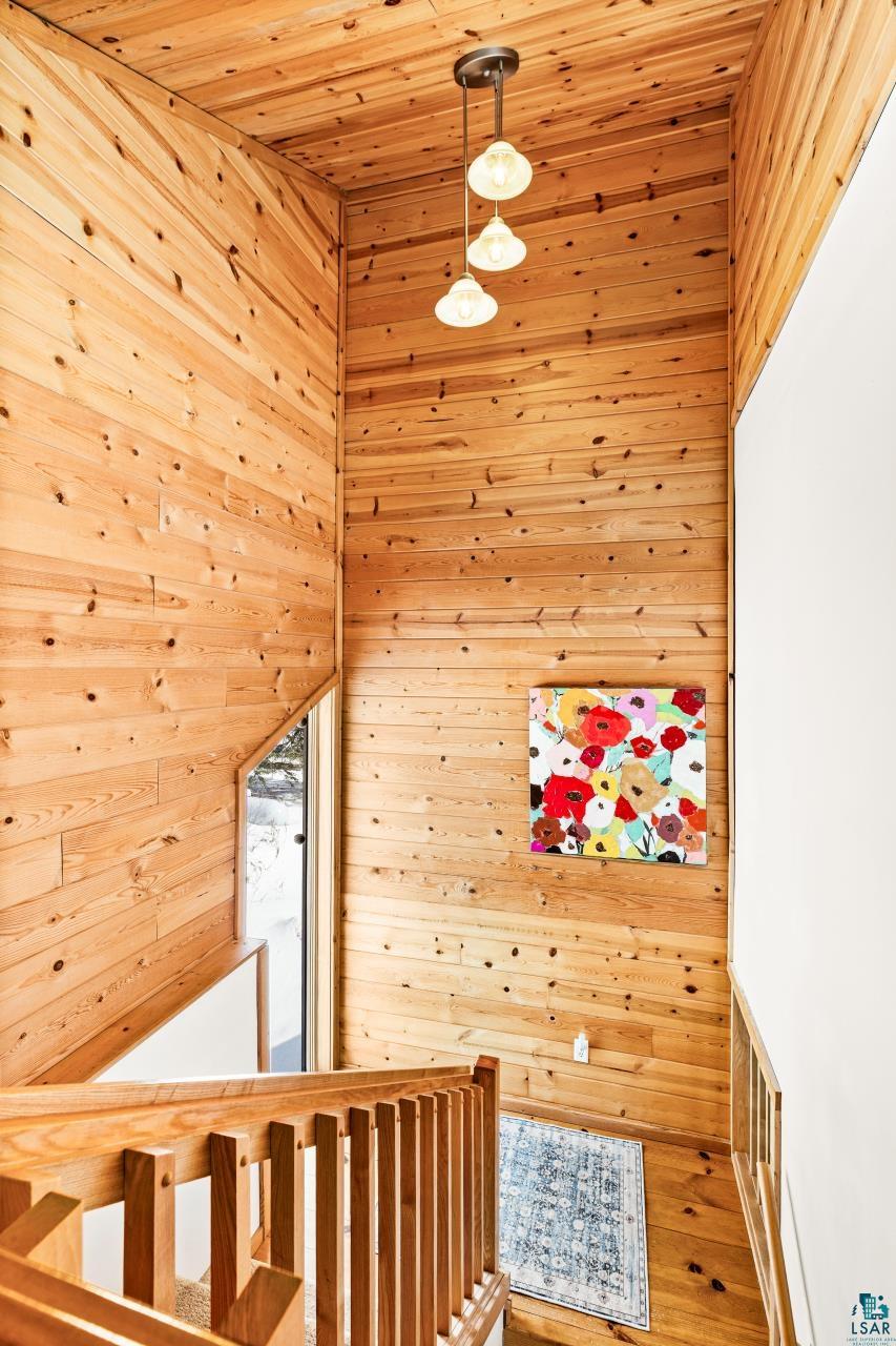67 Snowshoe Trail Tofte, MN 55615 - Photo 29 of 42 Corridor with wood walls and wooden ceiling