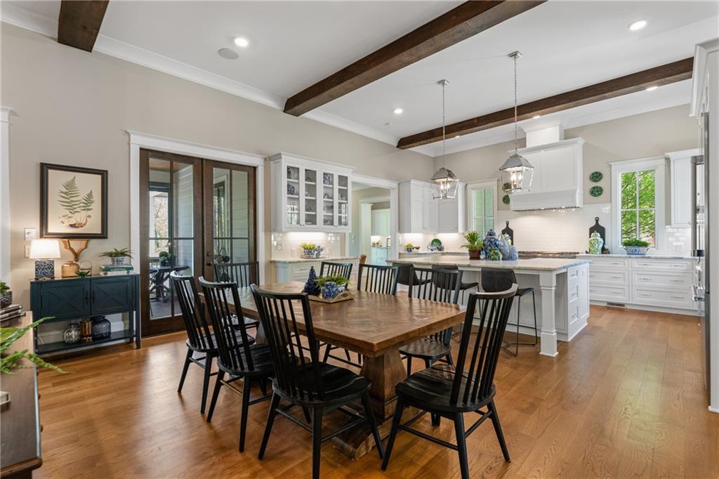 16200 Henderson Road Milton, GA 30004 - Photo 16 of 95 a view of a dining room with furniture and wooden floor