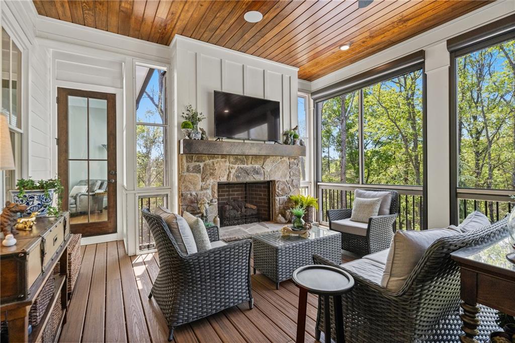16200 Henderson Road Milton, GA 30004 - Photo 23 of 95 a living room with furniture a flat screen tv and a fireplace
