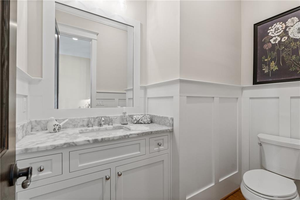 16200 Henderson Road Milton, GA 30004 - Photo 28 of 95 a bathroom with a granite countertop sink vanity mirror and toilet