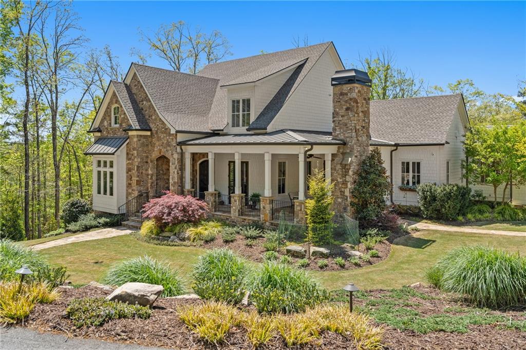 16200 Henderson Road Milton, GA 30004 - Photo 3 of 95 a view of a white house with a big yard and potted plants