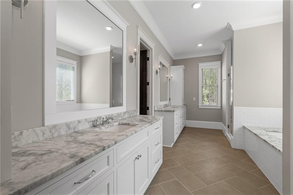 16200 Henderson Road Milton, GA 30004 - Photo 37 of 95 a spacious bathroom with a granite countertop sink mirror and a