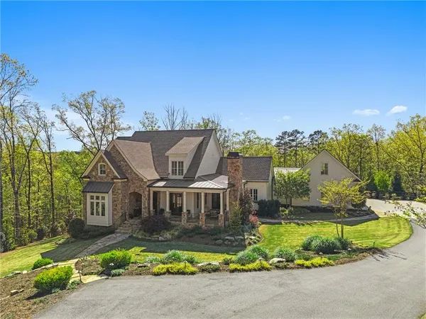 a view of a house with backyard sitting area and swimming pool