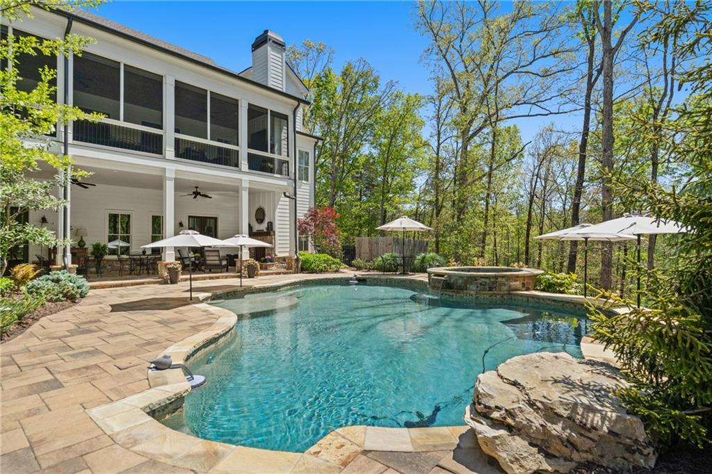 16200 Henderson Road Milton, GA 30004 - Photo 5 of 95 a view of a house with backyard sitting area and swimming pool