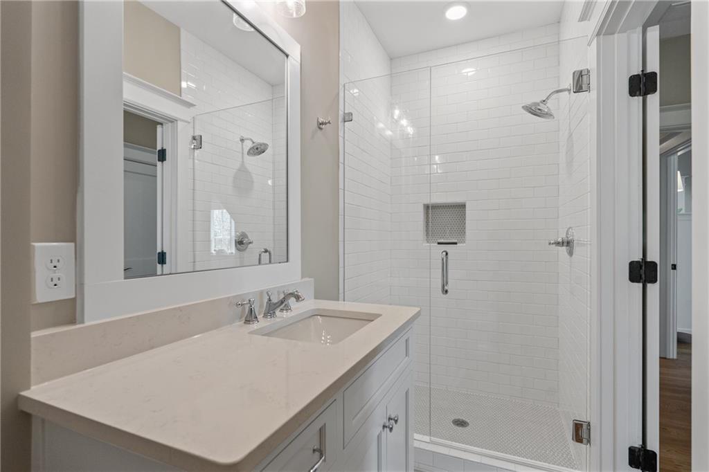 16200 Henderson Road Milton, GA 30004 - Photo 52 of 95 a bathroom with a sink vanity granite shower and a mirror