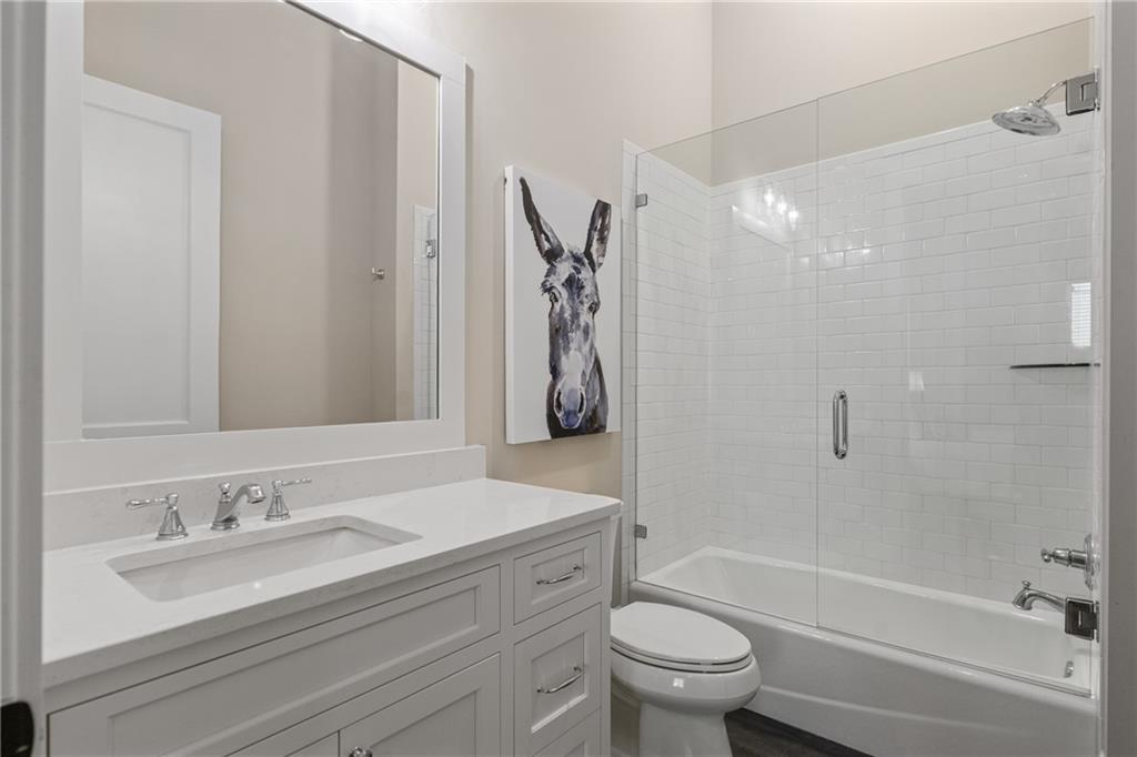 16200 Henderson Road Milton, GA 30004 - Photo 70 of 95 a bathroom with a granite countertop sink a toilet and a bathtub
