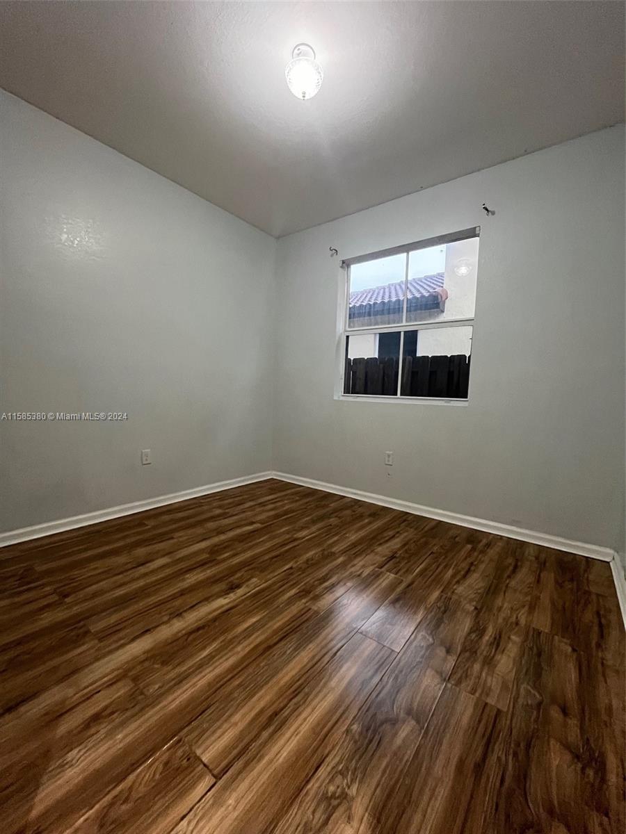 11879 Southwest 253rd Terrace Homestead, FL 33032 - Photo 11 of 26 a view of empty room with wooden floor