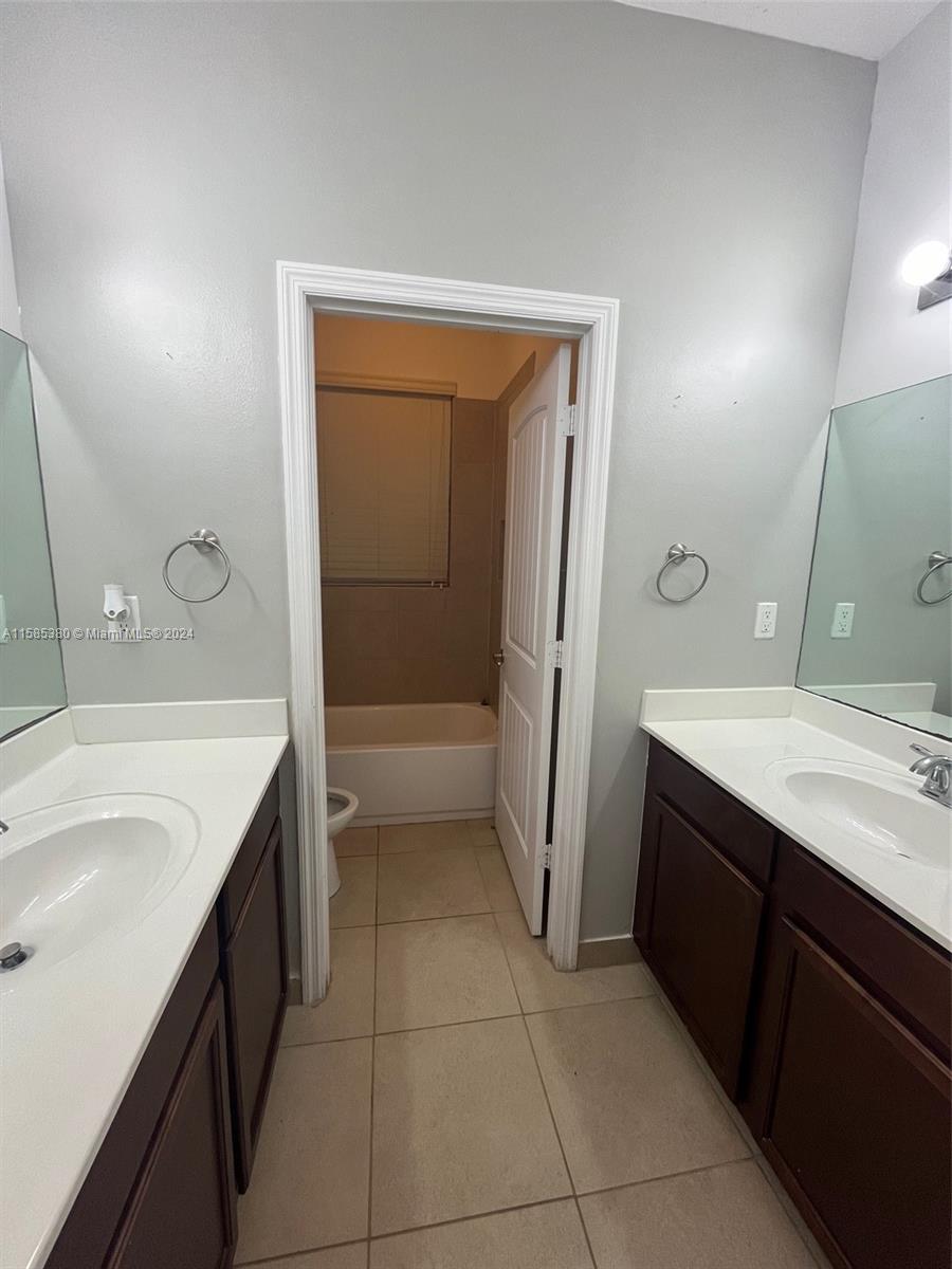 11879 Southwest 253rd Terrace Homestead, FL 33032 - Photo 13 of 26 a bathroom with a sink a toilet and a tub