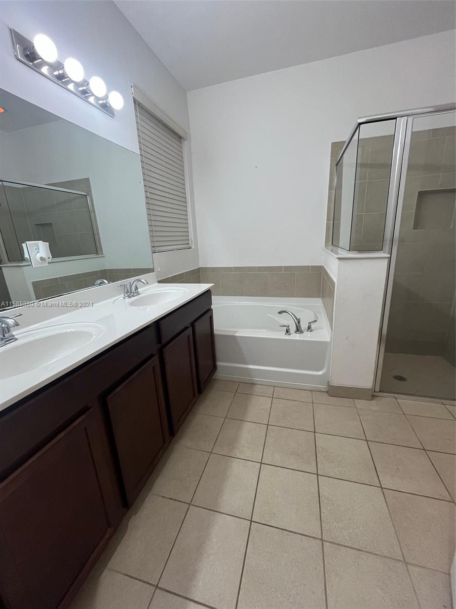 11879 Southwest 253rd Terrace Homestead, FL 33032 - Photo 15 of 26 a spacious bathroom with a tub sink and mirror