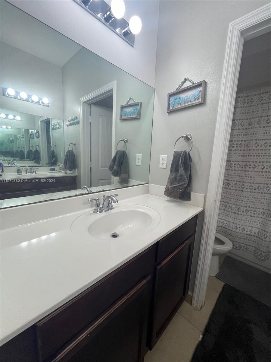11879 Southwest 253rd Terrace Homestead, FL 33032 - Photo 17 of 26 a bathroom with a sink and a mirror