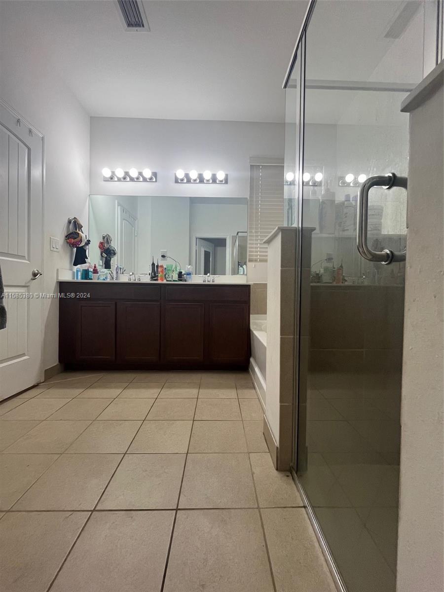 11879 Southwest 253rd Terrace Homestead, FL 33032 - Photo 18 of 26 a kitchen with stainless steel appliances granite countertop a refrigerator and a cabinets