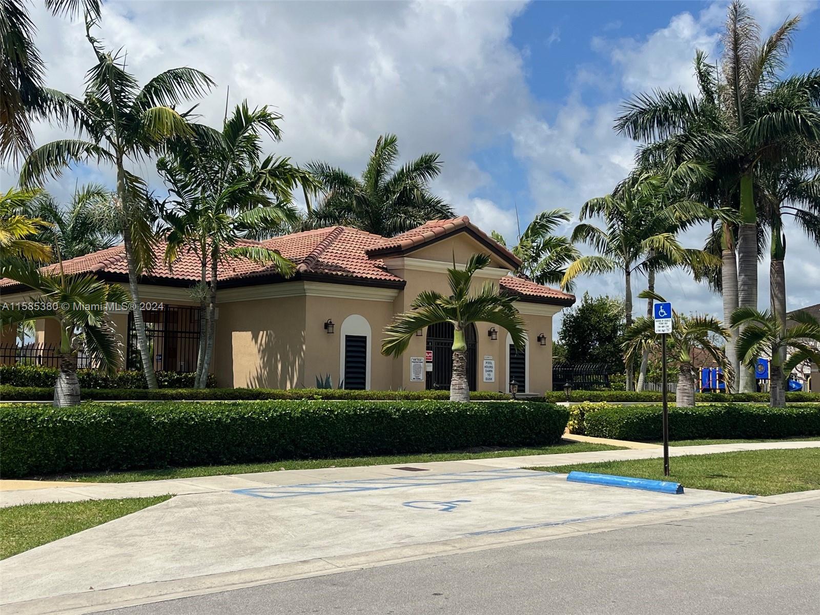 11879 Southwest 253rd Terrace Homestead, FL 33032 - Photo 23 of 26 a front view of a house with a garden