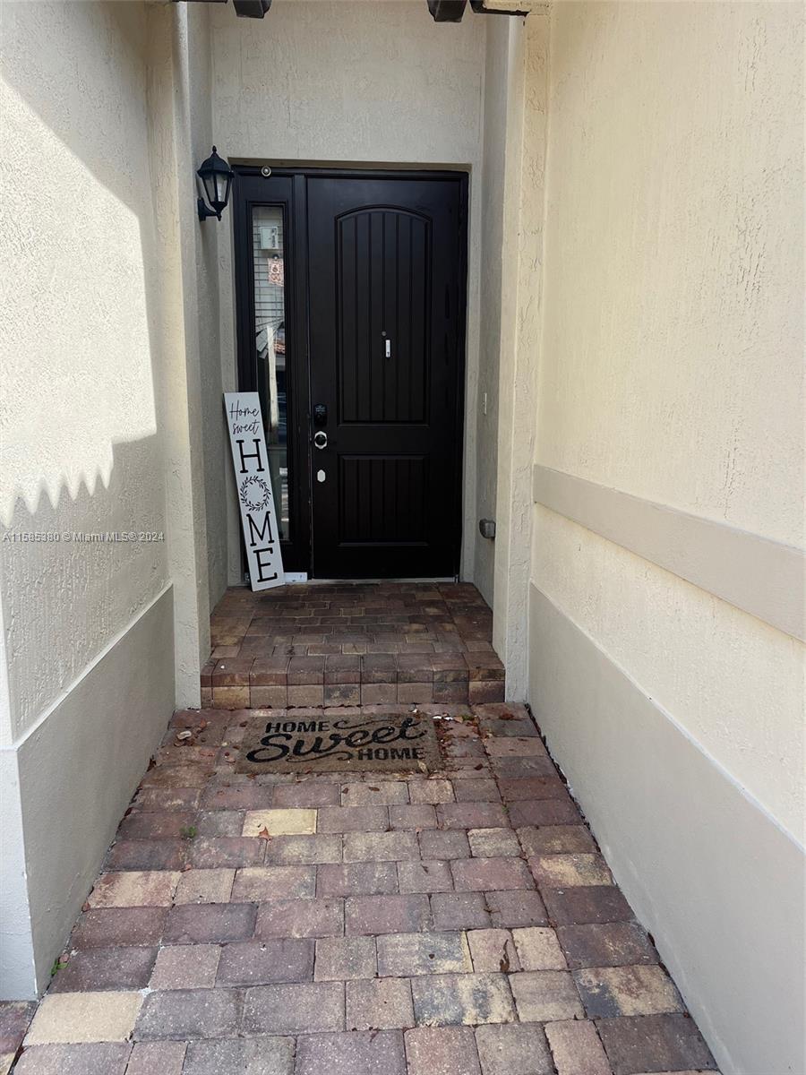 11879 Southwest 253rd Terrace Homestead, FL 33032 - Photo 4 of 26 a view of a entryway door of the house
