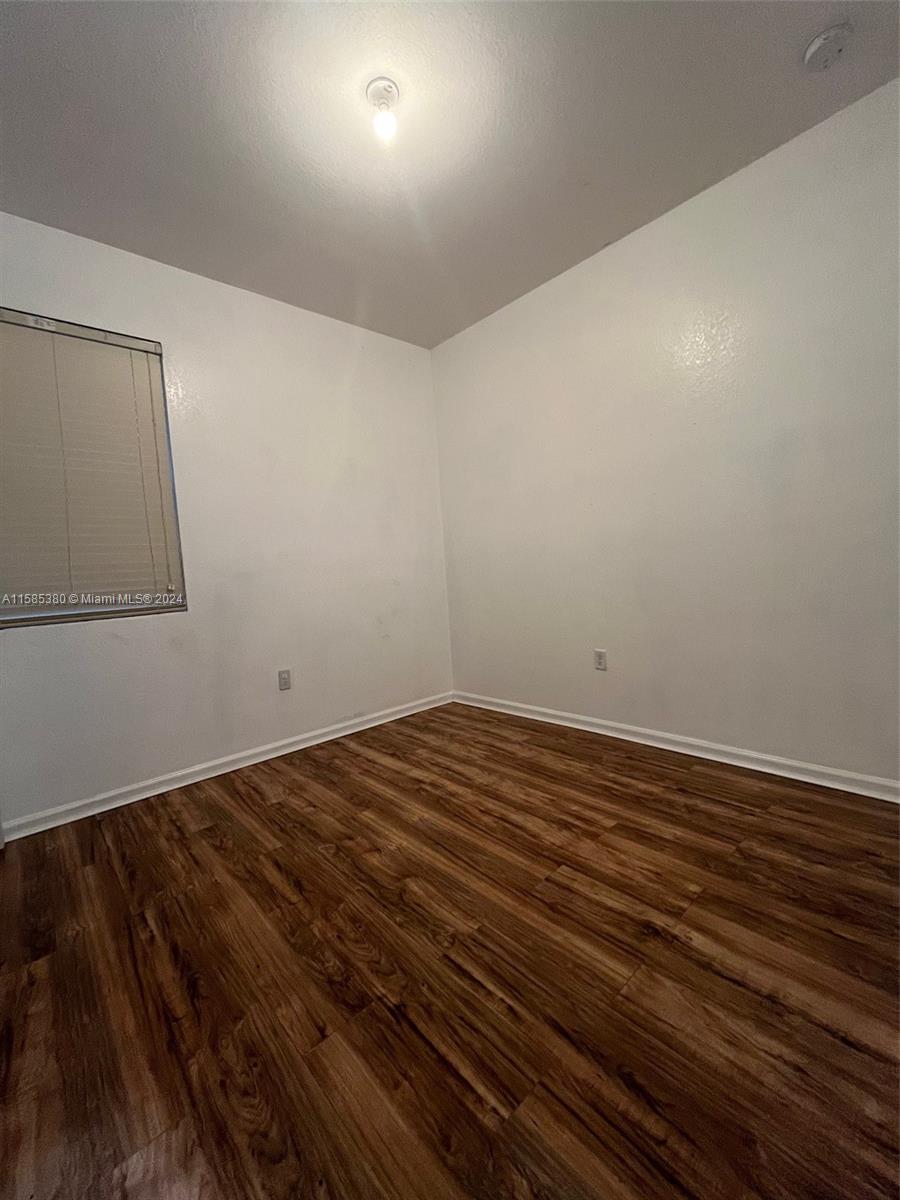11879 Southwest 253rd Terrace Homestead, FL 33032 - Photo 10 of 26 a view of empty room with wooden floor