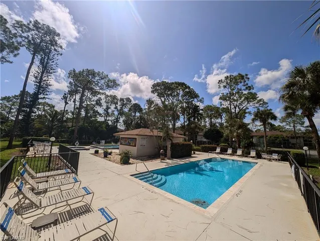 a view of a swimming pool and lounge chairs