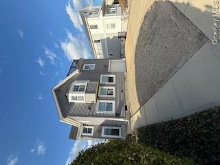 733 East Walnut Street, Unit UPPR Long Beach, NY 11561 - Photo 23 of 26 a front view of a house with a yard