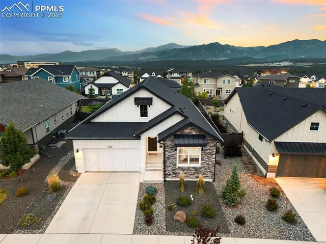an aerial view of a house with a yard