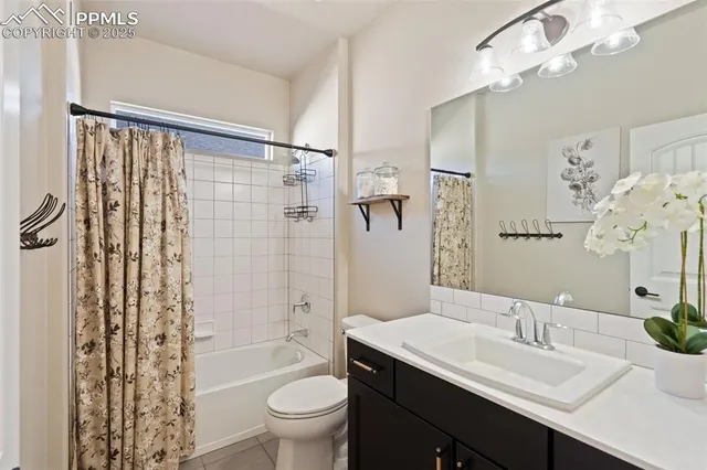 a bathroom with a sink a toilet a mirror a vanity and shower