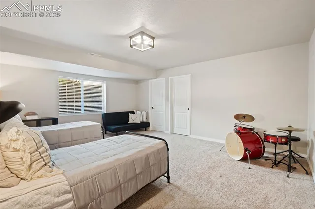 a bedroom with two beds and a chandelier