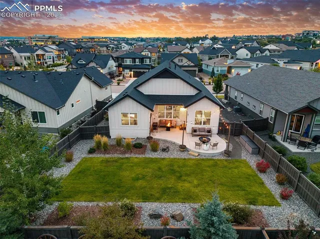 a aerial view of a house with swimming pool and a yard
