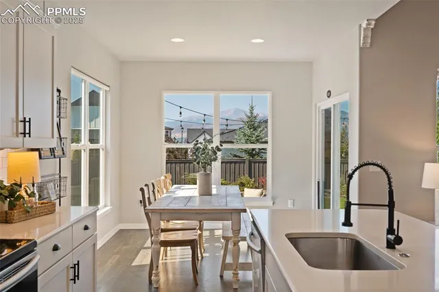 a kitchen with a table chairs and a sink
