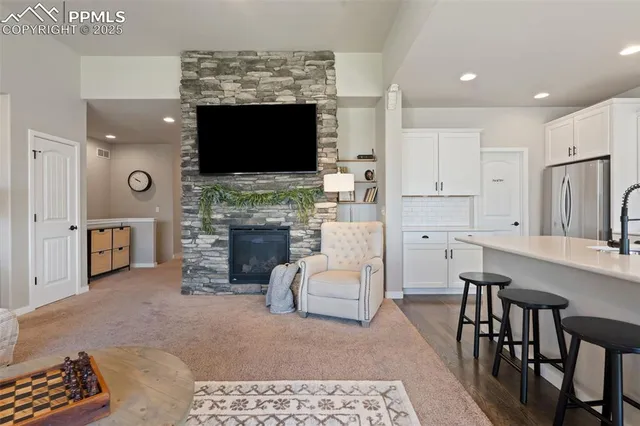 a living room with furniture a flat screen tv and a fireplace