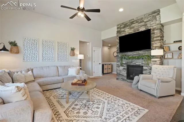 a living room with furniture a flat screen tv and a fireplace