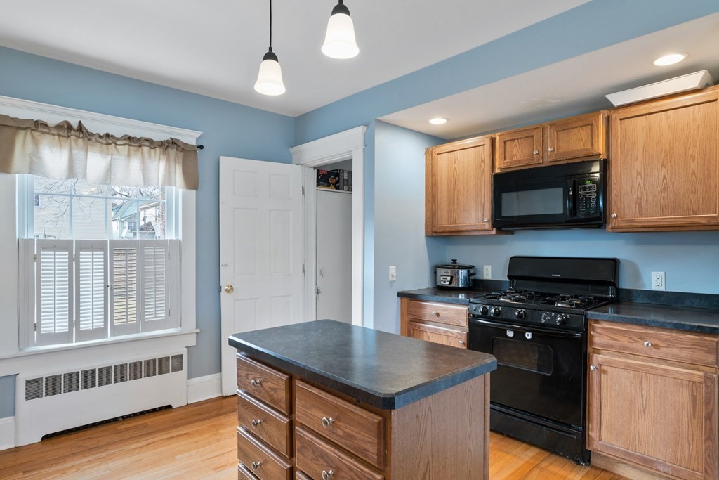 128 Shawmut Street Springfield, MA 01108 - Photo 16 of 39 a kitchen with stainless steel appliances granite countertop a stove a sink and a microwave